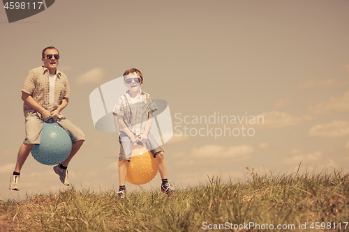 Image of Father and son playing on the field