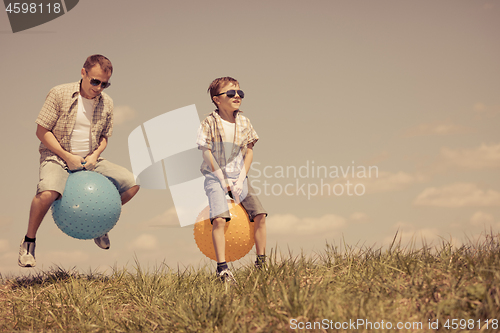 Image of Father and son playing on the field