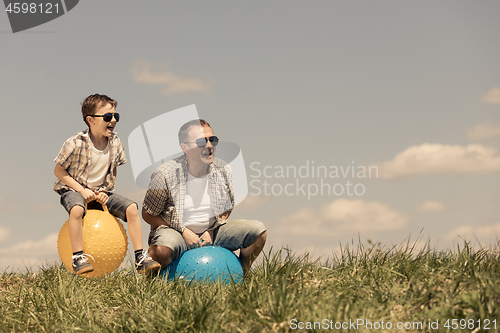 Image of Father and son playing on the field 