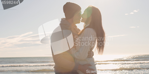 Image of Couple having fun on beautiful autumn day at beach