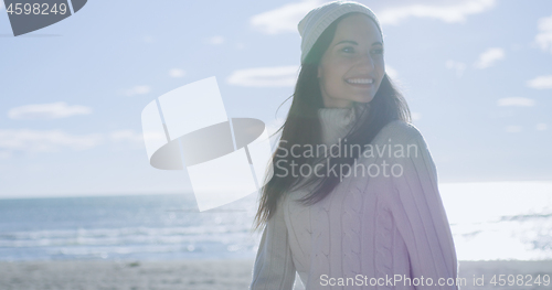 Image of Girl In Autumn Clothes Smiling on beach