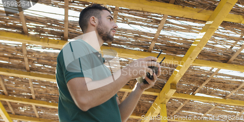 Image of Man Operating Drone By The Sea