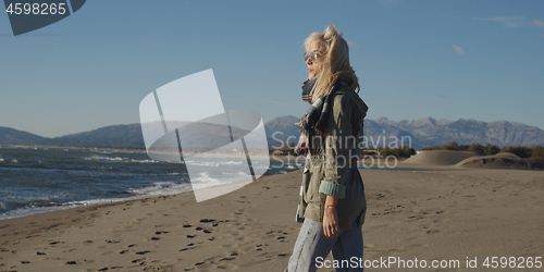 Image of Young woman enjoying the warm autumn day