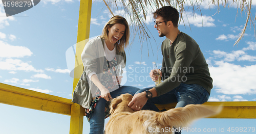 Image of Group of friends having fun on autumn day at beach