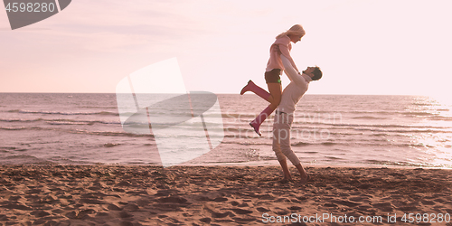 Image of Loving young couple on a beach at autumn on sunny day