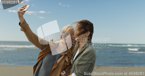 Image of Girls having time and taking selfie on a beach