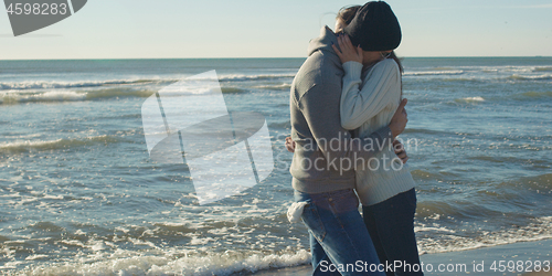 Image of Couple having fun on beautiful autumn day at beach