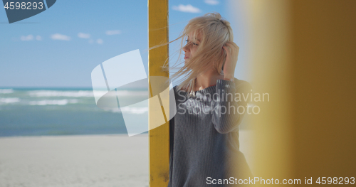 Image of Young woman enjoying the warm autumn day