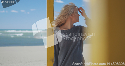 Image of Young woman enjoying the warm autumn day