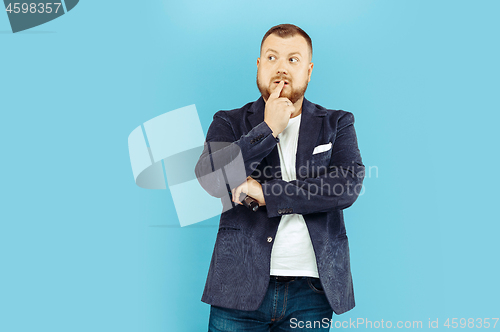 Image of Young man with microphone on blue background, leading concept