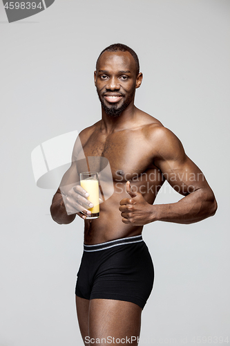 Image of Fit young man with beautiful torso isolated on gray background