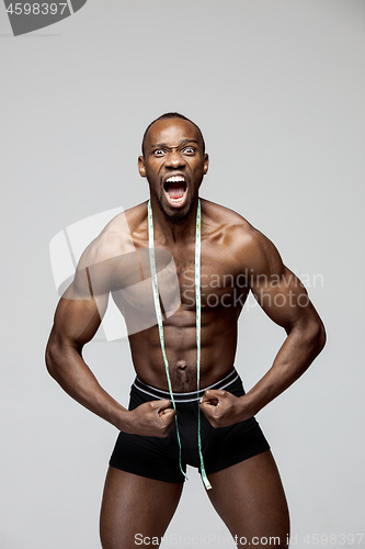 Image of Fit young man with beautiful torso isolated on gray background