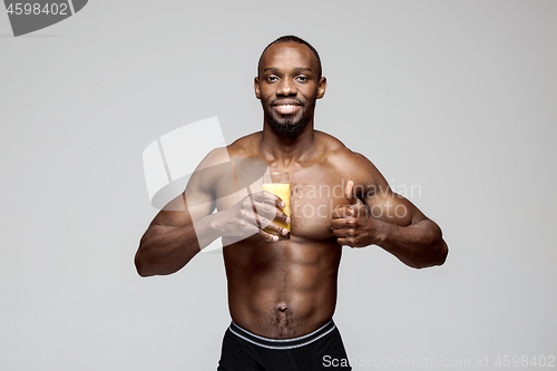 Image of Fit young man with beautiful torso isolated on gray background