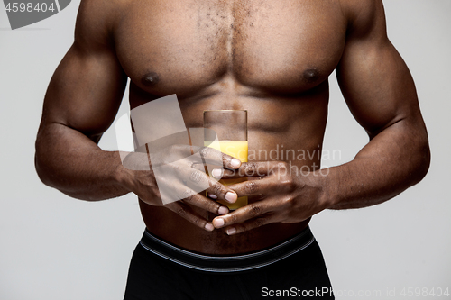 Image of Fit young man with beautiful torso isolated on gray background