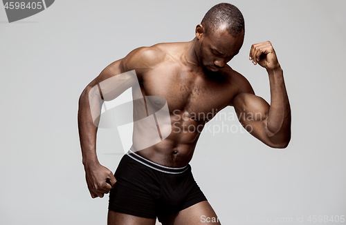Image of Fit young man with beautiful torso isolated on white background
