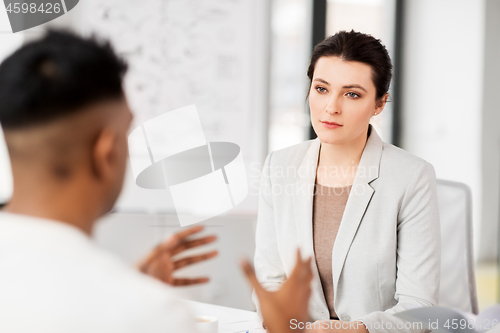 Image of employer having interview with employee at office