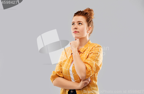 Image of red haired teenage girl in checkered shirt