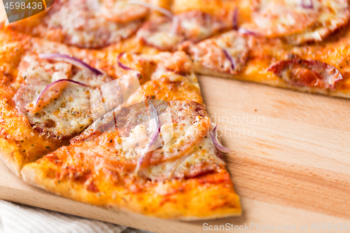 Image of close up of homemade pizza on wooden table