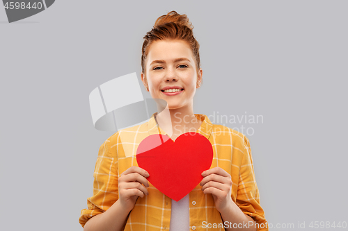 Image of smiling red haired teenage girl with heart