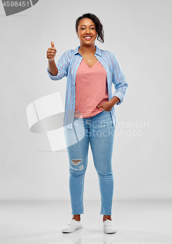 Image of happy african american woman showing thumbs up