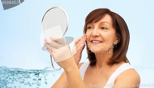 Image of portrait of smiling senior woman with mirror