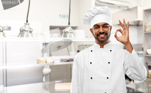 Image of indian chef showing ok sign at restaurant kitchen