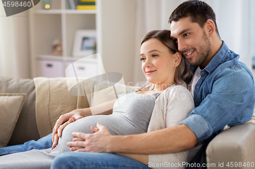 Image of man hugging pregnant woman at home