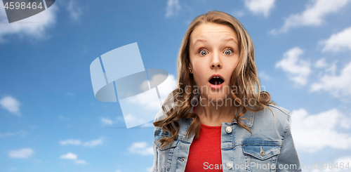 Image of surprised or shocked teenage girl over sky