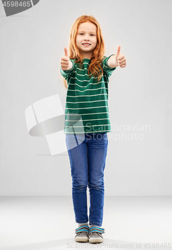 Image of smiling red haired girl showing thumbs up