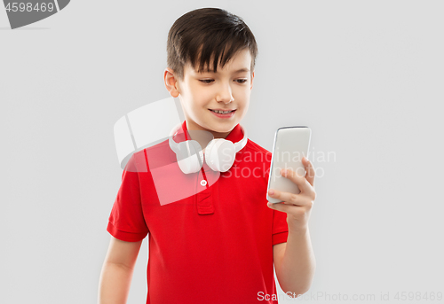 Image of boy in red t-shirt with headphones and smartphone