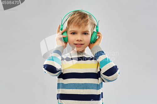 Image of smiling boy in headphones listening to music