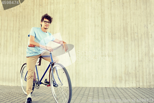 Image of young hipster man riding fixed gear bike