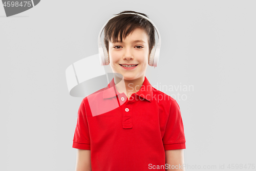 Image of smiling boy in headphones listening to music