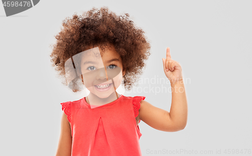 Image of little african american girl pointing finger up