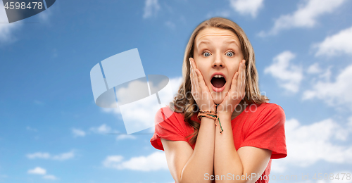 Image of shocked or scared teenage girl over sky