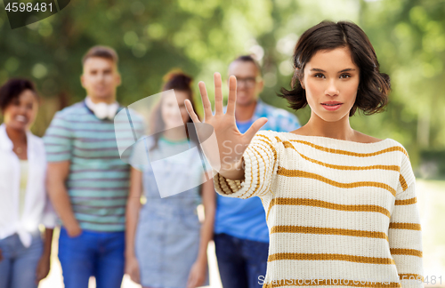 Image of young woman making stopping gesture