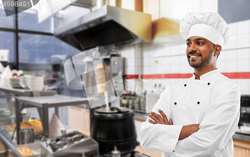 Image of happy male indian chef in toque at kebab shop