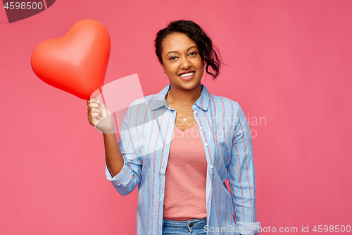 Image of african american woman with heart-shaped balloon