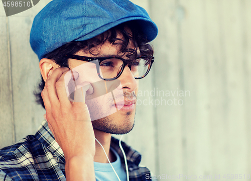 Image of close up of man with earphones listening to music