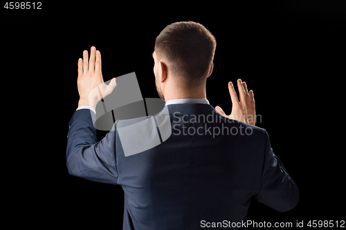 Image of businessman working with invisible virtual screen