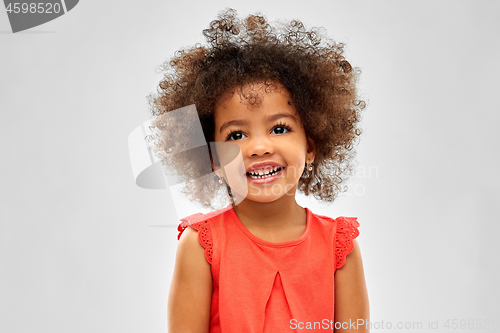 Image of happy little african american girl over grey