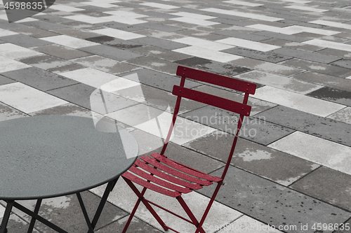 Image of Outdoor cafe with red chair and table