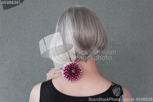 Image of Lady with beautiful silver hair and red dahlia