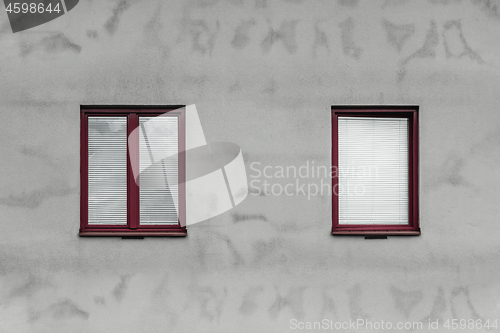 Image of Red windows and gray wall of a house