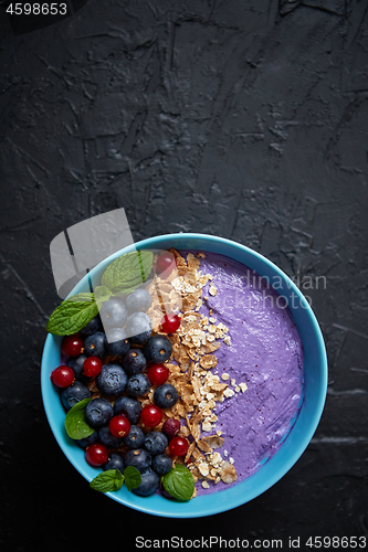 Image of Healthy food concept. Fresh fruit Blackberries and currants yogurt or smoothie with oat and flakes