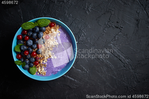 Image of Healthy food concept. Fresh fruit Blackberries and currants yogurt or smoothie with oat and flakes
