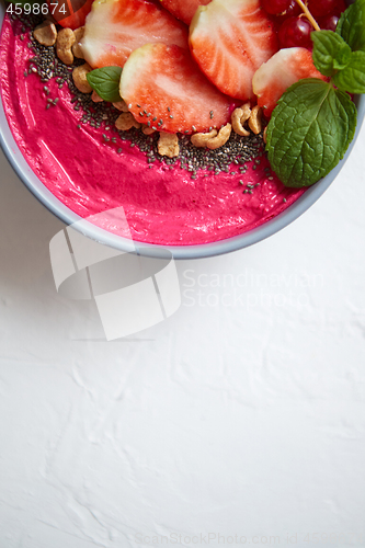 Image of Summer berry smoothie or yogurt bowl with strawberries, red curr