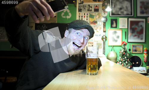 Image of Guy and phone in the bar