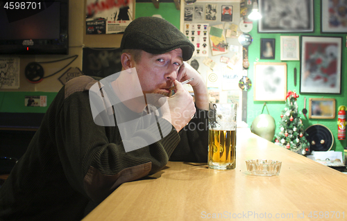 Image of Guy smokes in the bar