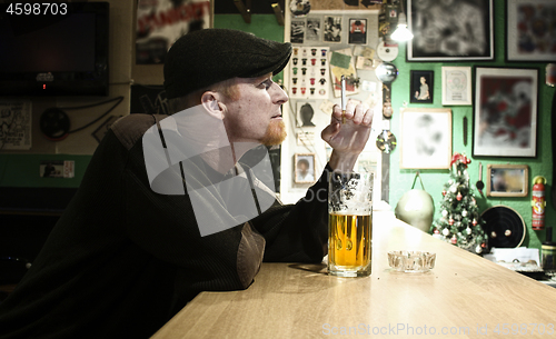 Image of Guy smokes in the bar